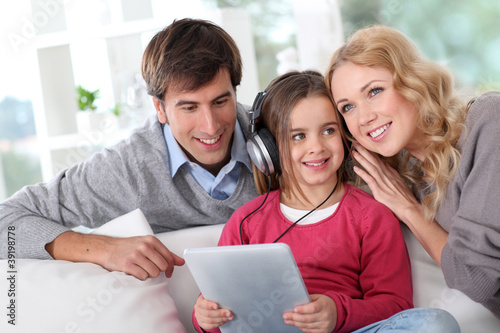 Photo: Family listening to music with tablet Family listening to music with tablet