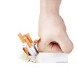 Man's hand crushing cigarettes on white background