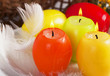 Easter eggs-candles with bows in the basket over floral Easter eggs-candles with bows in the basket over floral