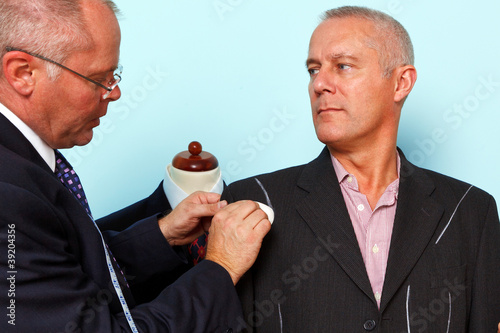 Photo: Bespoke suit adjustment by a tailor Bespoke suit adjustment by a tailor