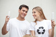 Photo: Couple holding light bulbs Couple holding light bulbs