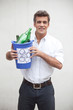 Photo: Man holding a trash bin with glass bottles Man holding a trash bin with glass bottles