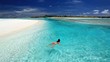 Young woman swimming in tropical lagoon