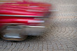 red car in blurred motion red car in blurred motion