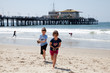Girl and Boy Playing on the Beach