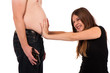 girl pushing against her boyfriends beer belly