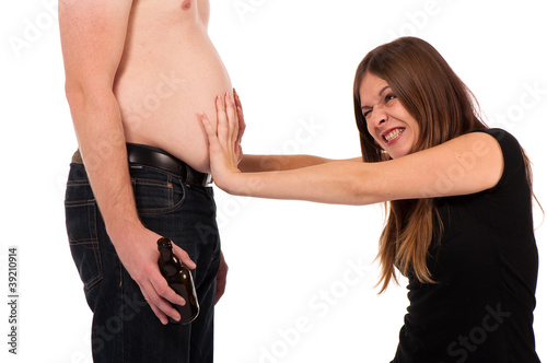 Photo: girl pushing against her boyfriends beer belly girl pushing against her boyfriends beer belly