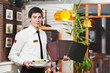 waiter in uniform at restaurant