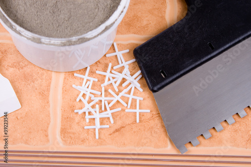 Photo: Ceramic tiles and trowel for repairs Ceramic tiles and trowel for repairs