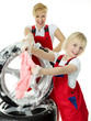 Blonde sisters in overall faving fun while cleaning a wheel
