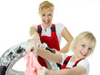 Blonde sisters wearing overalls washing a wheel
