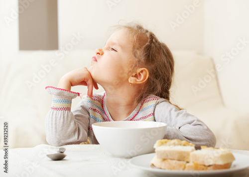 Photo: Girl looks with disgust for food Girl looks with disgust for food