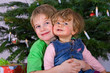 Foto: brother and sister in front of christmastree brother and sister in front of christmastree