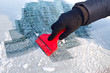 Scraping ice from the car window