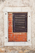 Photo: Wooden window inside a larger concrete window with bricks inside Wooden window inside a larger concrete window with bricks inside