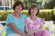 Portrait of two senior friends smiling in a park