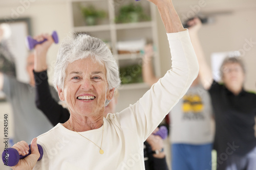 Photo: Seniors exercising with dumbbells in a health club Seniors exercising with dumbbells in a health club