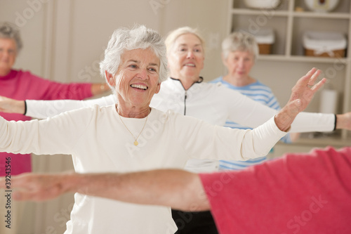 Photo: Seniors doing arm strengthening exercises in a health club Seniors doing arm strengthening exercises in a health club
