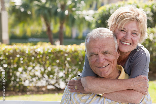 Photo: Portrait of a woman hugging a man from behind Portrait of a woman hugging a man from behind