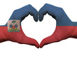 Heart and love gesture in haiti flag colors by hands isolated on