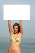 A gorgeous model holding a blank sign in the air A gorgeous model holding a blank sign in the air