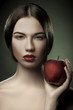 Photo: Portrait of caucasian young woman with apple Portrait of caucasian young woman with apple