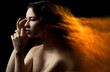 Photo: Photo of beautiful woman with fiery hair on black background Photo of beautiful woman with fiery hair on black background