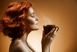 Stylish woman with an aromatic coffee in hands Stylish woman with an aromatic coffee in hands
