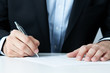 Close up of office worker filling documents