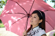 Pretty chinese woman holding umbrella