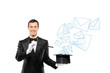 Smiling magician and mails coming out of a top hat Smiling magician and mails coming out of a top hat