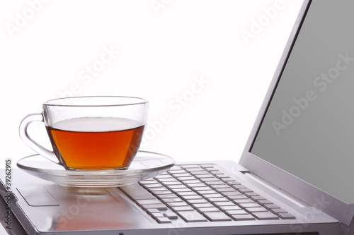 Photo: cup of tea and laptop cup of tea and laptop