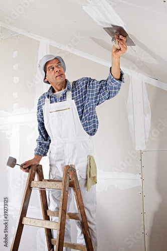 Photo: studwork: filling the joints of the plaster boards studwork: filling the joints of the plaster boards