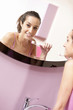 young woman in bathroom cleaning her teeth