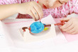 Foto: Child painting Easter eggs Child painting Easter eggs