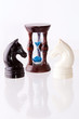 Two chess horses with sand-clock