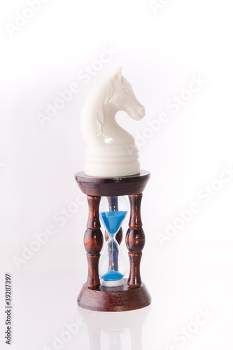 Photo: White chess horse with sand-clock White chess horse with sand-clock