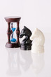 Two chess horses with sand-clock