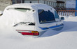 Snow covered car in the snowdrift after cyclone Snow covered car in the snowdrift after cyclone