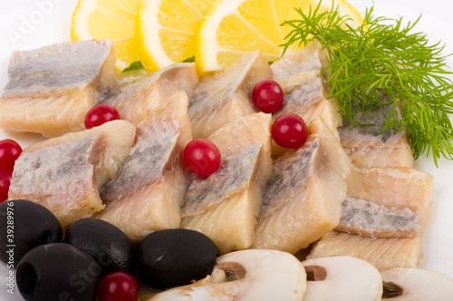 Photo: Testy cut herring with vegetable on the plate Testy cut herring with vegetable on the plate