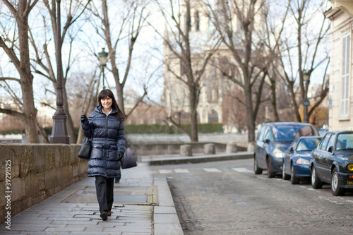 Photo: Pretty brunette female tourist walking in Paris Pretty brunette female tourist walking in Paris