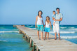 Family of four on jetty by the ocean