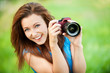 Young smiling woman with camera