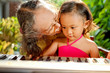 ethnic child and grandma playing piano together ethnic child and grandma playing piano together