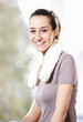 Beautiful sporty girl is smiling and resting in a gym.