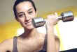 portrait of  young woman lifting free weights