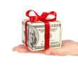 dollars in the form of a gift box in hand isolated on white