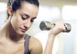 portrait of  young woman lifting free weights