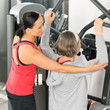 Fitness center trainer senior woman exercise shoulder