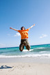 The young man jumps at the sea